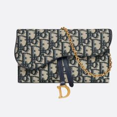 The Long Saddle Wallet With Chain, Crafted In Blue Dior Oblique Jacquard, Is A Hybrid Item With A Modern And Streamlined Design. The Style Is Embellished With An Asymmetric Flap Featuring An Antique Gold-Finish Metal 'D' Stirrup. Thanks To Its Removable Chain Strap, The Wallet Can Be Worn Over The Shoulder, Crossbody Or Carried By Hand. Front 'D' Stirrup 6 Card Slots 3 Patch Pockets 1 Removable Zipped Pouch Made In Italy Luxury Blue Clutch With Detachable Strap, Luxury Wallet On Chain For Daily Use, Luxury Blue Bags With Chain Detail, Luxury Blue Bags With Chain, Luxury Blue Bag With Chain Detail, Luxury Blue Chain Bags, Dior Saddle Wallet, Saddle Pouch, Dior Purse