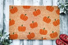 an orange door mat with pumpkins on it