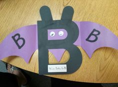 a paper bat cut out on top of a table with the letter b in it