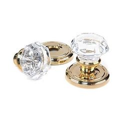 two brass and crystal knobs on white background