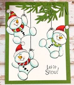 two snowmen hanging from a christmas tree with the words let it snow on them