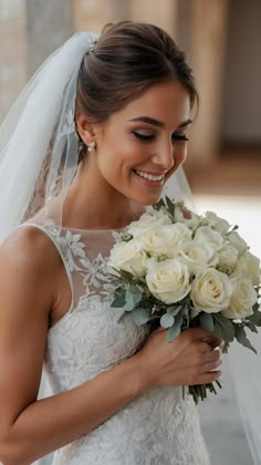 a bride smiles as she holds her bouquet