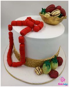 a white cake with red decorations on top