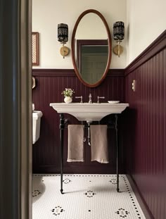 a white sink sitting under a mirror in a bathroom