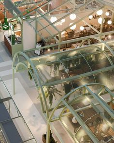 an overhead view of the inside of a building with glass walls and plants growing in it