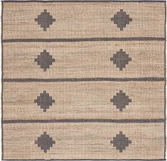 an area rug with black and white designs on the bottom, in front of a beige background