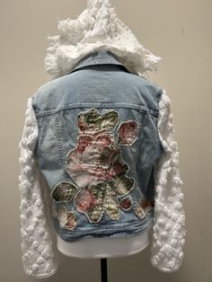 a denim jacket with flowers on the back