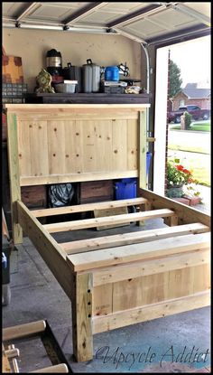 the bed frame is made out of wood and ready to be used as a headboard