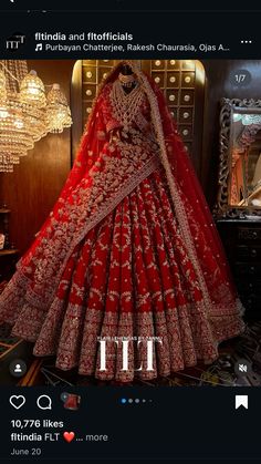 a red bridal gown is displayed in front of a mirror