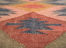 an old rug with colorful designs on it