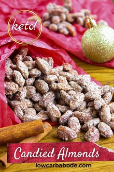 a bag full of candied almonds next to a christmas ornament