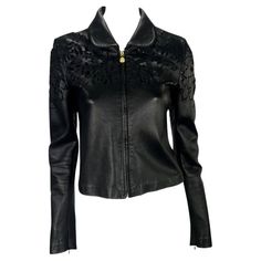 Presenting a sleek black Gianni Versace leather jacket designed by Donatella Versace. This collared leather jacket features a flat, rounded collar, cut floral design, and Medusa logo zipper pulls. The unique floral cut-out details on the coat have a layer of black mesh under the leather, maintaining the dark look. Approximate measurements: Size - 40IT Shoulder to hem: 20” Bust: 32” Waist: 30” Shoulder to cuff: 25" Underarm to cuff: 19" Spring Evening Leather Jacket, Spring Long Sleeve Leather Jacket For Evening, Versace Leather Jacket, Vintage Designer Bags, Dark Look, Versace Outfit, Donatella Versace, Chic Leather, Gianni Versace