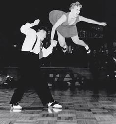 two young men are dancing on the dance floor