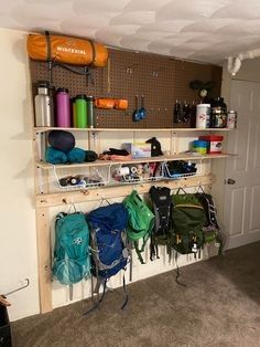 a room with several backpacks hanging on the wall