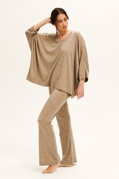 Material: 100% Australian merino wool.Description: Made from lightweight 100% Australian Merino wool, it is an oversized fit top with a scoop neckline. Loose three-quarter sleeves. One size fits most. It's the perfect combination of understated yet elegant. Wear yours with any of our matching Mia pants, for a chic lounge set. Wool is renowned for its ability to regulate body temperature, it has insulating qualities to trap dry air and warmth near the skin in winter. Wool is naturally insulating Oversized Fine Knit Tops For Loungewear, Oversized Long Sleeve Merino Wool Top, Oversized Merino Wool Long Sleeve Tops, Oversized Merino Wool Crew Neck Top, Fall 3/4 Sleeve Tops For Loungewear, Oversized 3/4 Sleeve Tops For Loungewear, Oversized Beige Top With 3/4 Sleeves, Beige Oversized Top With 3/4 Sleeves, Long Sleeve Merino Wool Tops For Loungewear