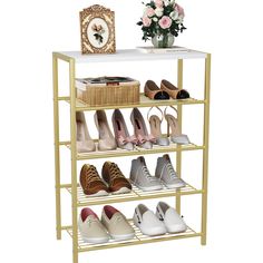 four tiered shoe rack with white top and gold legs, holds several pairs of women's shoes