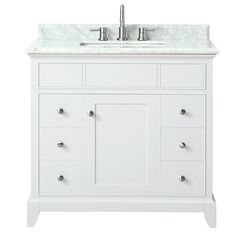 a white bathroom vanity with marble top and two faucets on the sink area