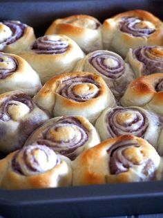 a pan filled with cinnamon rolls sitting on top of a table