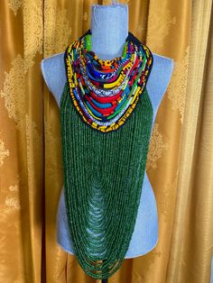 Handmade with perfection is the statement piece necklace, green sea beads adorned this piece along with corded African print mixed fabric collar. Hand tie for self adjusting... take up space when you make your entrance Green Multi-strand Beaded Necklaces For Festivals, Green Multi-strand Beaded Necklace For Festival, Green Large Beads Party Necklace, Bohemian Green Necklace, Green Large Beads For Party, Green Bohemian Beaded Necklaces For Party, Bohemian Green Beaded Necklaces For Party, Bohemian Green Beaded Necklace For Party, Green Multi-strand Beaded Necklaces With Large Beads