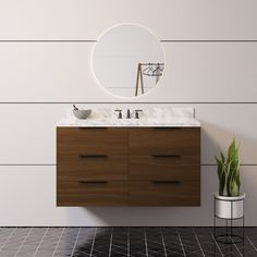 a bathroom vanity with a round mirror above it