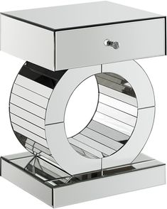 a chrome plated table with a circular design on it's base and shelf