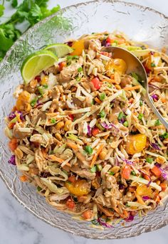 a glass bowl filled with shredded chicken salad