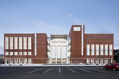 an empty parking lot in front of a brick building