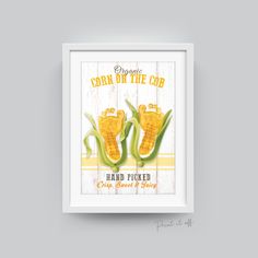 corn on the cob poster is displayed in a white frame with an old wood background