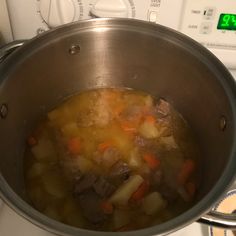 a pot filled with soup sitting on top of a stove