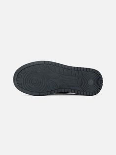 the sole of a black shoe on a white background