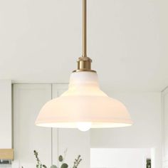 a white light hanging over a kitchen counter