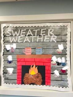 a fire place made out of paper and wood with the words sweater weather written on it