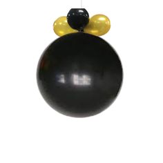 a black and yellow balloon hanging from the ceiling