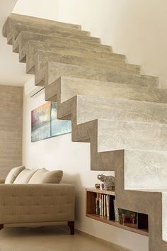 a living room filled with furniture and a stair case