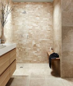 a bathroom with a sink, toilet and bathtub next to a shower head mounted on a wall