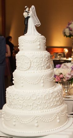 a white wedding cake sitting on top of a table