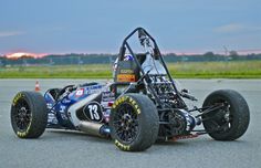 a small race car is parked on the pavement