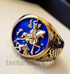 St George's and the dragon heavy man ring round 10K gold historical religious Greek Orthodox Christian all sizes jewelry Risk free Quality guarantee policy : If you are not satisfied with your item for any reason simply send it to us and you will get a replacement or refund . gold : 10 k gold Approx. ring weight : 18.00 grams stamped 10K nice gift box included . certificate invoice from our shop of weight and gold purity . 10K Gold is used and blue enamel. Face width 18 mm , band width 7 mm FULL Blue Polished Enamel Ring, Blue Enamel Polished Round Ring, Blue Enamel Ring With Polished Finish, Antique Collectible Enamel Ring, Gold 14k Hallmarked Enamel Ring, Antique Gold Enamel Ring In 14k Gold, Engraved Yellow Gold Enamel Ring Collectible, 14k Stamped Yellow Gold Enamel Ring, Engraved 14k Gold Enamel Ring