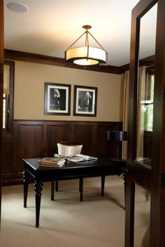 a living room filled with furniture and framed pictures on the wall above a coffee table