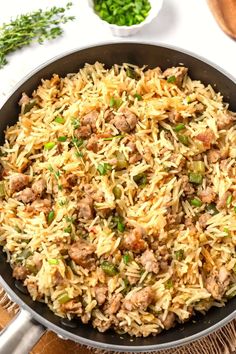 a skillet filled with rice and meat