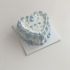 a heart shaped cake sitting on top of a card