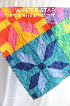 a colorful quilt with the words winter star modern quilt pattern written across it in white