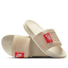 a pair of beige slides with red and white logo on the side, one is open to