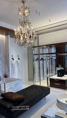 a bathroom with a chandelier hanging from the ceiling next to a bathtub