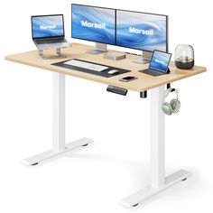 a computer desk with two monitors and headphones on it, sitting next to each other