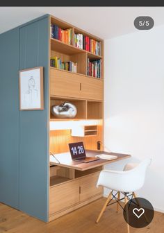 a room with a desk, bookshelf and chair next to a wall mounted bookcase