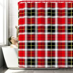 a bathroom with a shower curtain that has a red and black plaid pattern on it