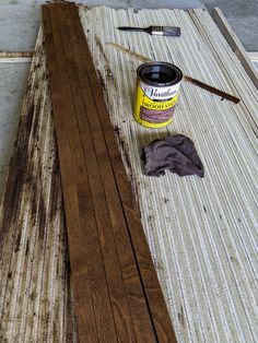 a can of paint sitting on top of a wooden table