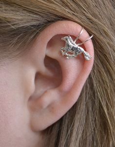 This is an extremely unique ear cuff featuring a running horse. It fits comfortably and securely on the top of your ear with no piercing. Spruce up your western style with this beautiful cuff. Metals available: *Gold Filled *Sterling Silver Available in: *Single Side *Pair Arrives in a pretty Gift Box and includes Simple Fitting Instructions. Perfect for gift giving! Unique Adjustable Pierced Ear Climbers, Adjustable Unique Style Ear Climbers, Unique Adjustable Nickel-free Ear Climbers, Unique Adjustable Pierced Ear Cuff, Adjustable Unique Ear Cuff, Unique Pierced Ear Cuff As A Gift, Unique Sterling Silver Cartilage Earrings, Fake Ear Piercings, Unique Ear Cuffs