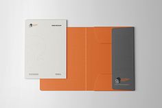 an orange folder with a notepad attached to the cover is shown in this image